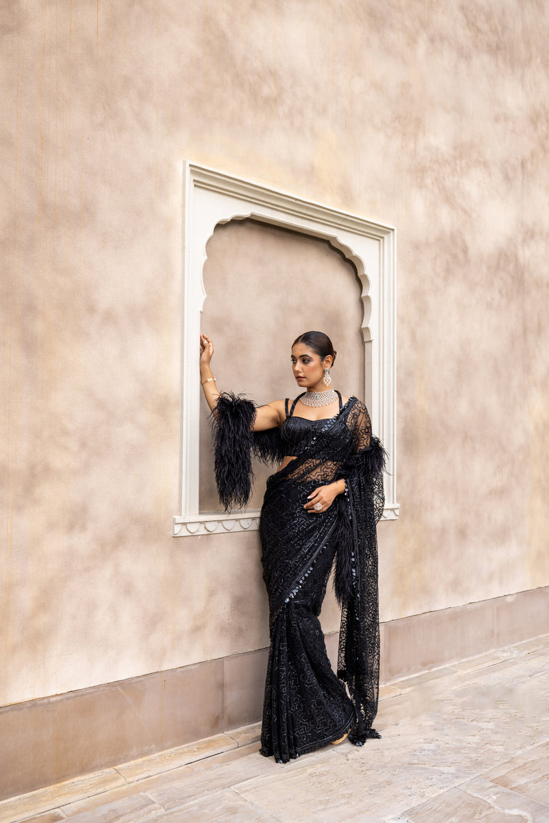 Romantic power dressing in a jet black saree. The lavish blouse is  hand-embroidered on black tulle with vintage thre…